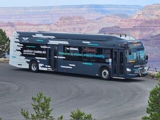 a modern and new electric bus on the rim of the Grand Canyon