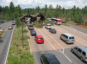 a line of cars at an entrance station to a national park