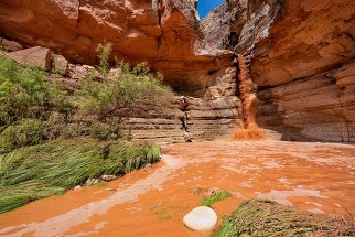a fast flowing waterfall in a desert canyon