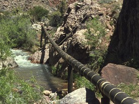 a pipeline running through a desert canyon