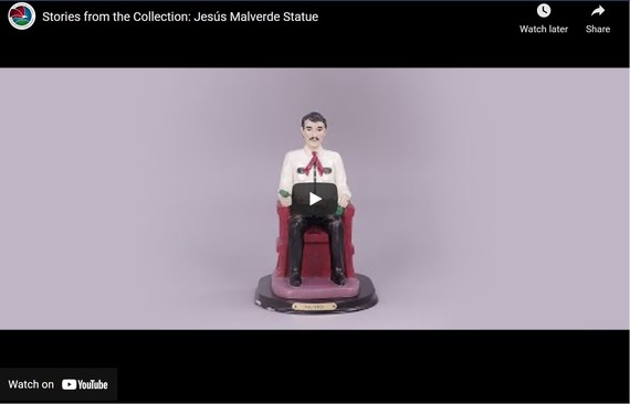 A still of a painted Malverde statue from a YouTube video. 