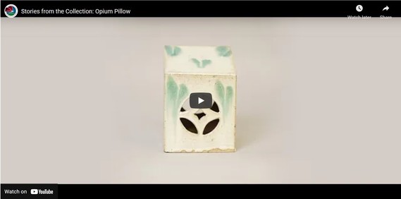 A YouTube video with a ceramic opium pillow on screen.