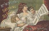 A woman reading her two children an advertisement in a newspaper.