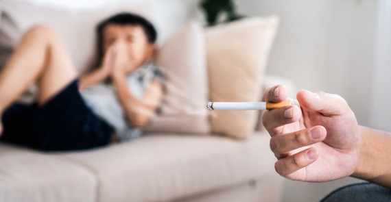 Father smokes near son