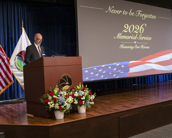 Administrator Cole at podium 2026 memorial