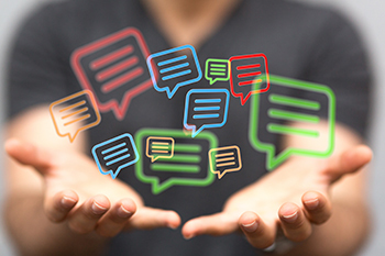 chat graphic - hands holding animated chat bubbles