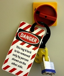 Lockout/tagout - Photo showing a lock and tag with the words "This tag & lock to be removed only by person shown on the other side"