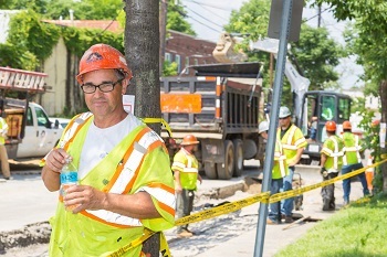 Construction worker taking a break from working in the heat.