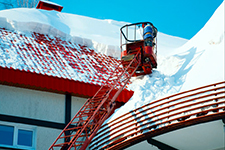 Protect workers from falls when removing snow from rooftops.