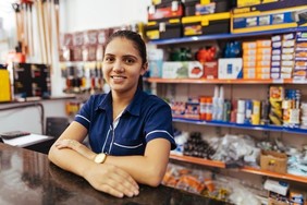Retail worker standing behind counter
