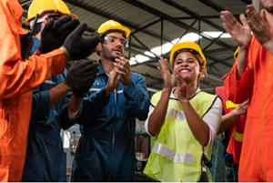 Woman in construction with her colleagues clapping