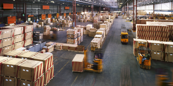 View from above inside a busy huge industrial warehouse