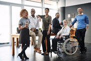 Diverse group of people standing side by side and smiling