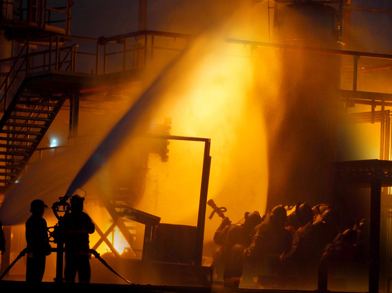 firefighters putting out a big fire at night