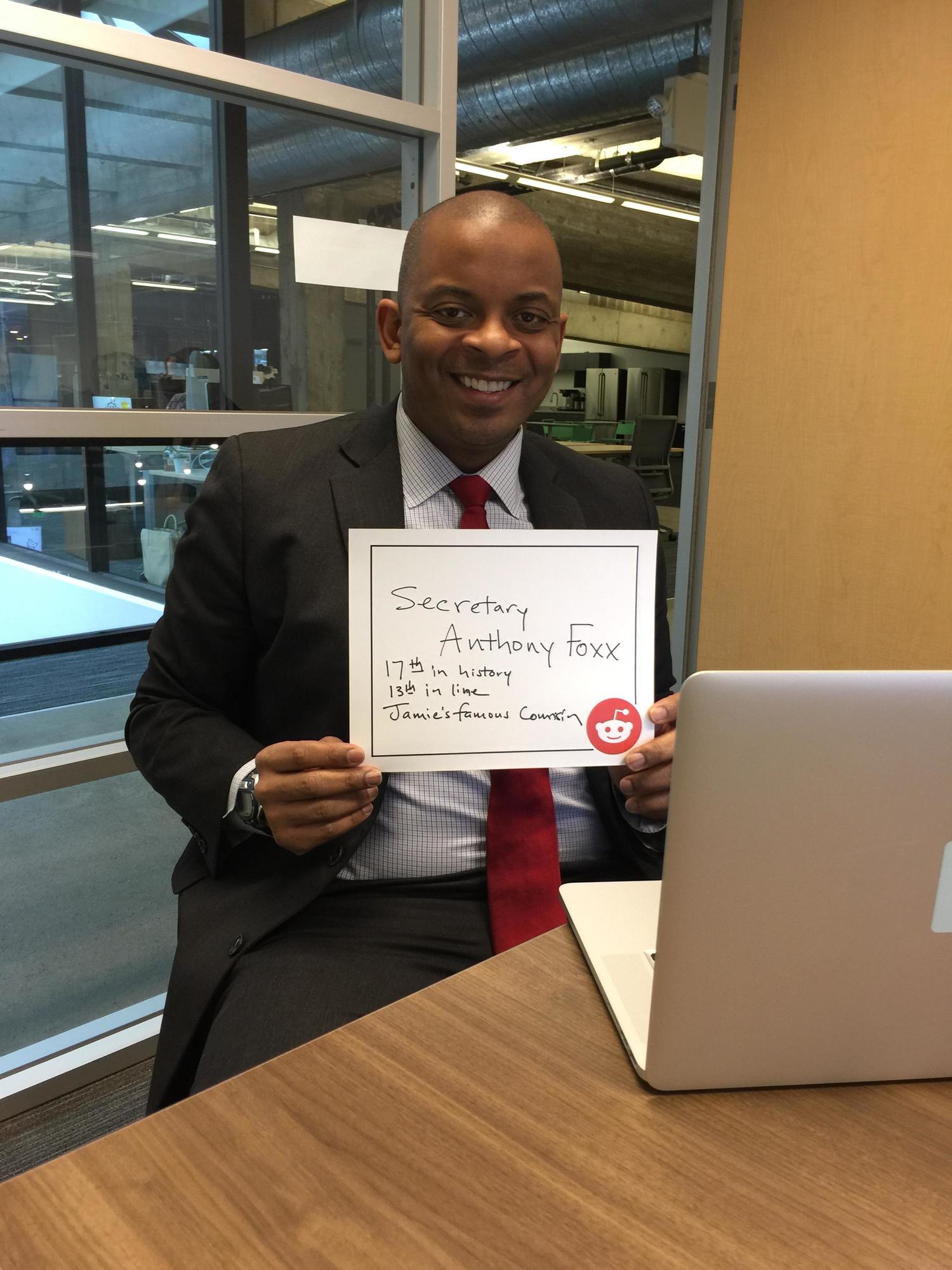 Anthony Foxx Holding A  Sign 