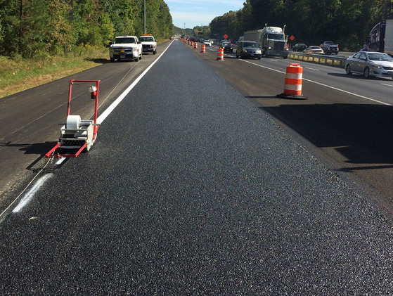 Roadway with HiMA on right side and traditional pavement on left side.