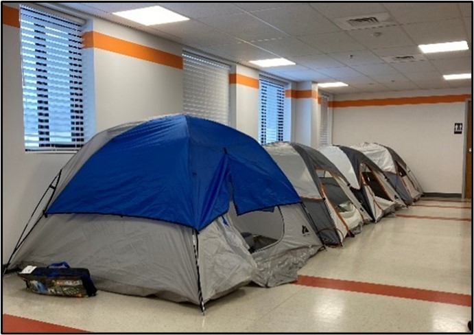 tents line a hallway to protect workers from getting sick.