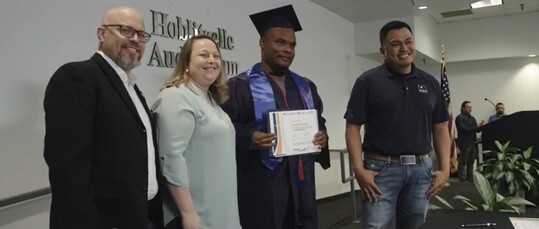 Stakeholders in the Texas Department of Transportation ConnectU2Jobs workforce development program stand with a recent graduate of the program.