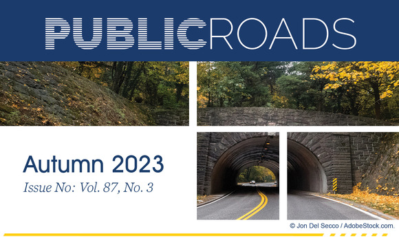 A stone tunnel, surrounded by dense fall foliage, spans a road with cars passing through. Copyright Jon Del Secco/AdobeStock.com