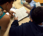 Woman teaching young boy to read