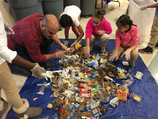 Long Branch Middle School students conduct a waste audit with their principal.