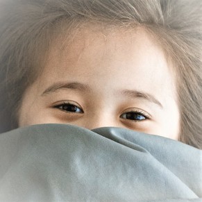 girl peeking from sheets