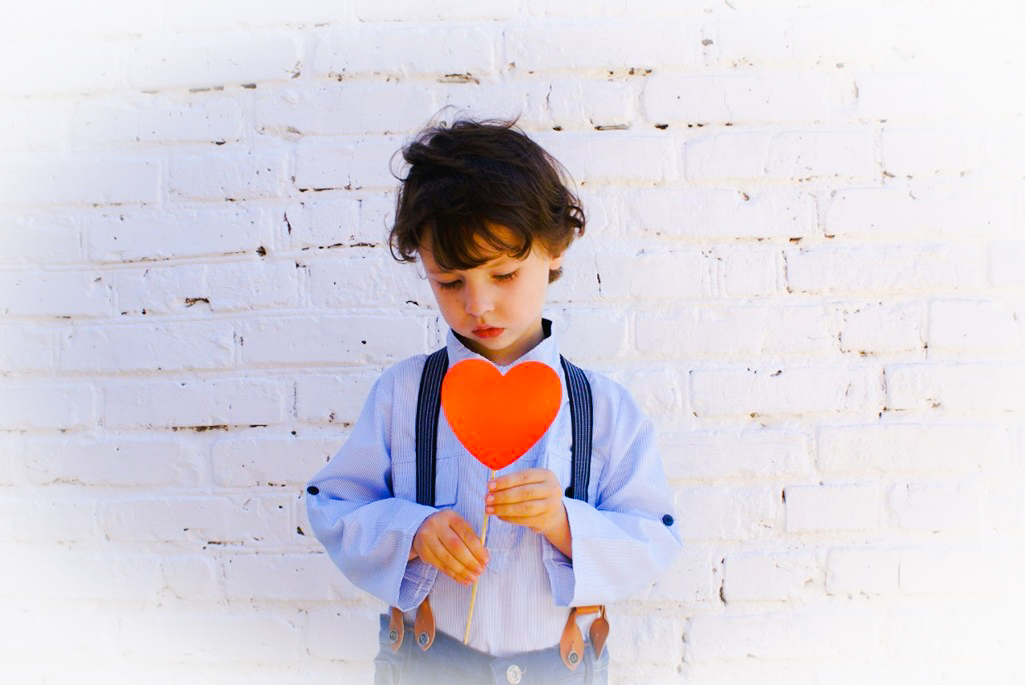 boy holding heart cutout