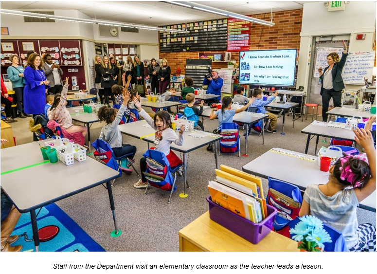 Department staff visit an elementary classroom