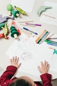 Child drawing on a large piece of paper