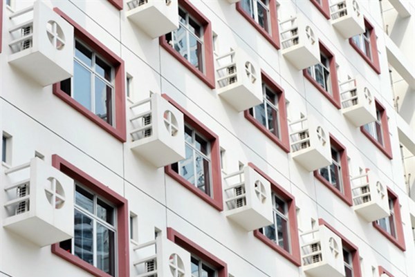 Side of a building with air conditioners and windows