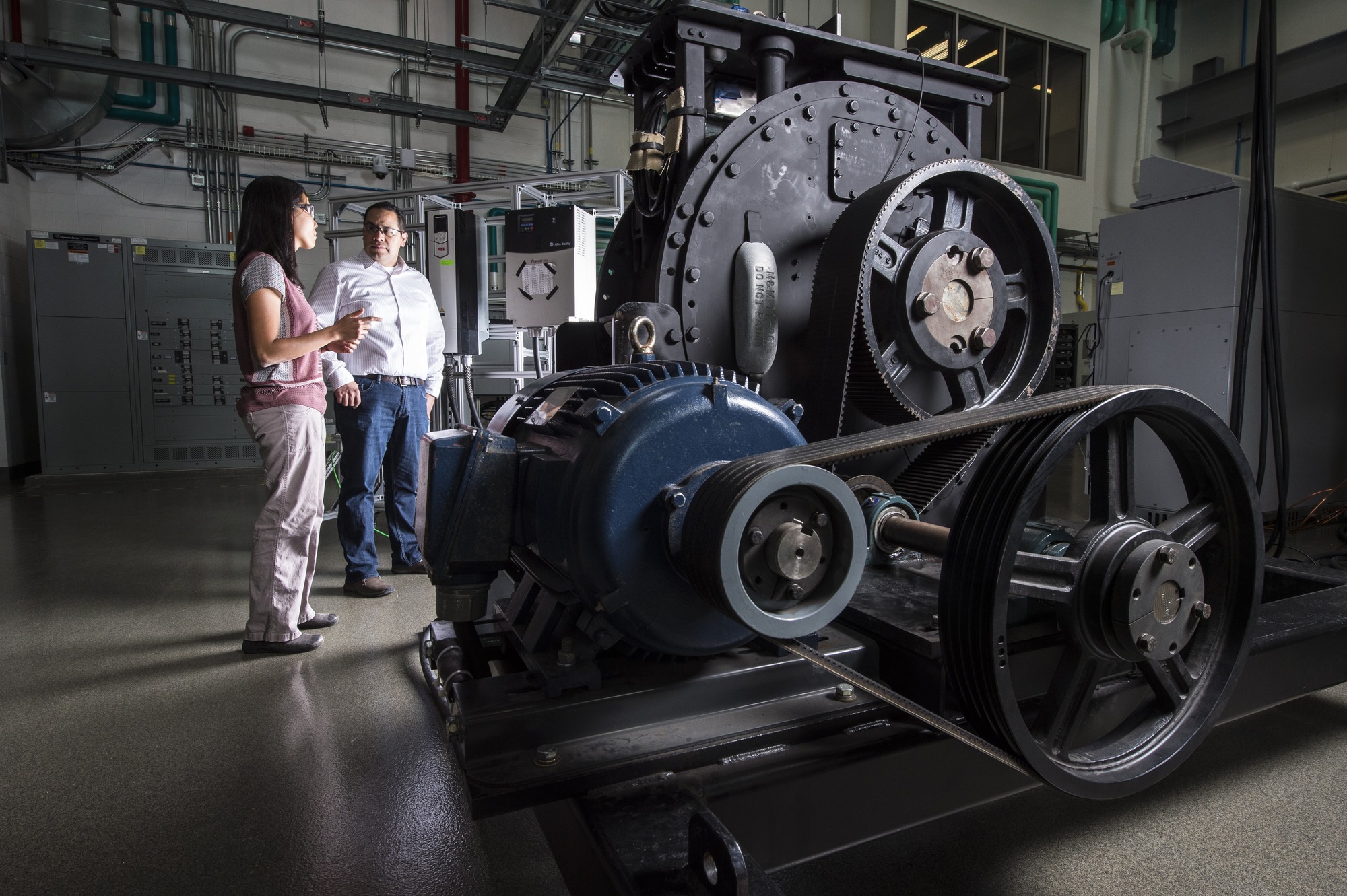 Two people  evaluating the performance of the generator and power conversion components of the company's RivGen® Power System at the ESIF.