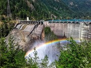 Hydropower dam with a rainbow in the mist of the rushing water.