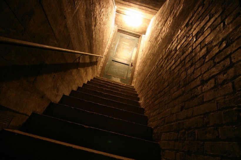 View up the stairs from a dark basement