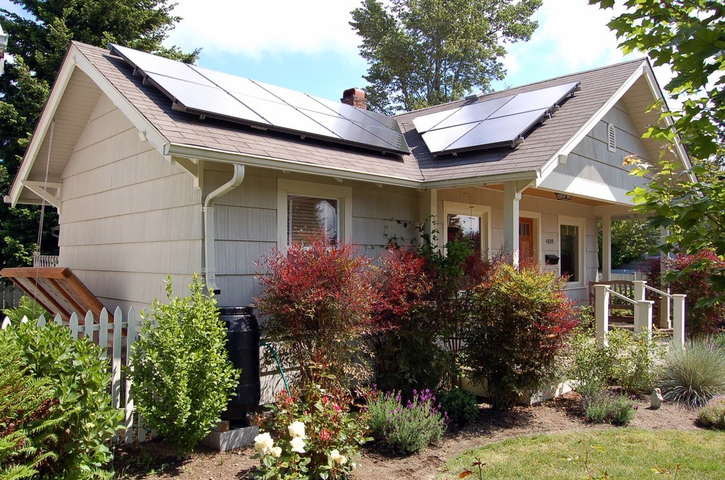 Cottage home with rooftop solar panels