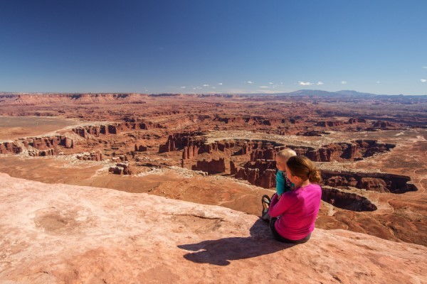 Woman and child sitting at an overlook in Canyonlands National Park