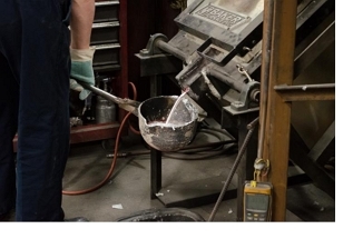 molten metal being poured into a ladle. 