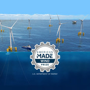 Several wind turbines mounted on floating platforms float atop a deep body of water.