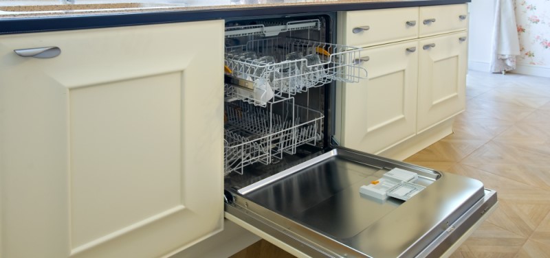A dishwasher built into a kitchen counter, sitting open