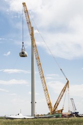 Crews lower the nacelle as part of the decommissioning of the 3-MW Alstom wind turbine at NREL’s National Wind Technology Center.