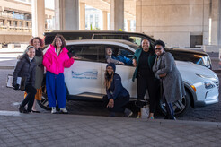 Group photo of Ride n' Drive participants next to a fuel cell vehicle powered by hydrogen fuel