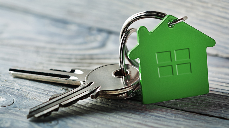 Keys with a green house-shaped keychain
