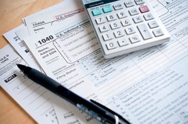Tax forms, a pen, and calculator