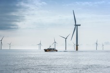 Floating wind turbines in the ocean with a ship. 