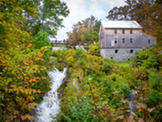 A hydropower facility with water falling below it among trees