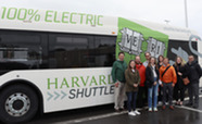 Joint Office Staff poses in front of electric bus.