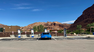 Blue car charges at Utah NEVI station.