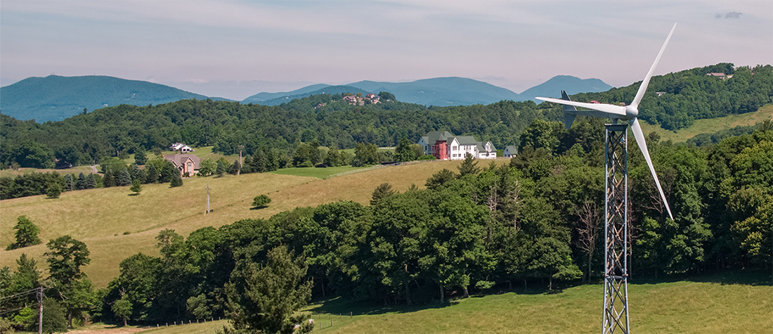 Wind turbine in foreground and farmland in background