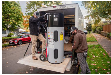Installers unload a heat pump water heater. Photo courtesy of Hot Water Solutions