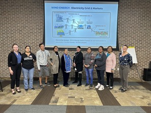 People standing in front of a projector screen