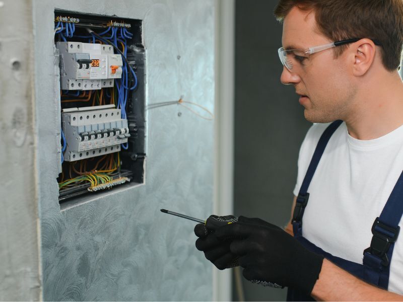 Man working on an electric panel.